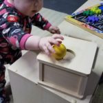 baby using object permanence box