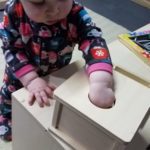 baby using object permanence box