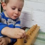 toddler using cylinder blocks