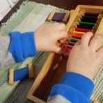 boy using montessori color box 2